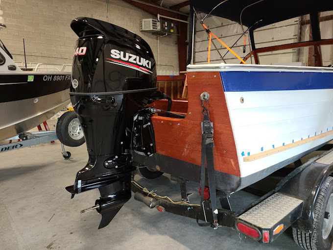 Suzuki outboard motor being serviced in the shop
