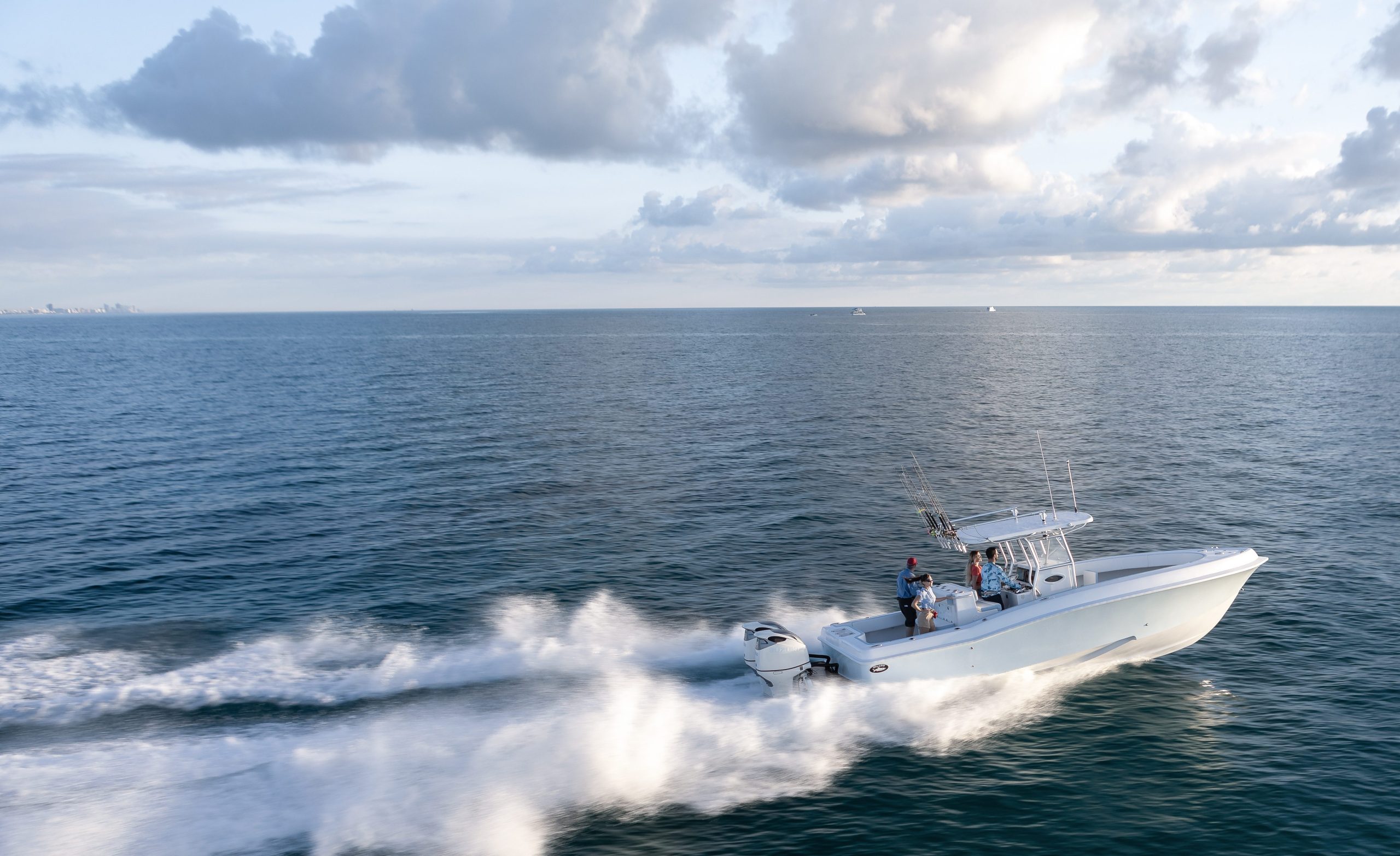 Center console boat powered by twin Suzuki outboards speeding across the water